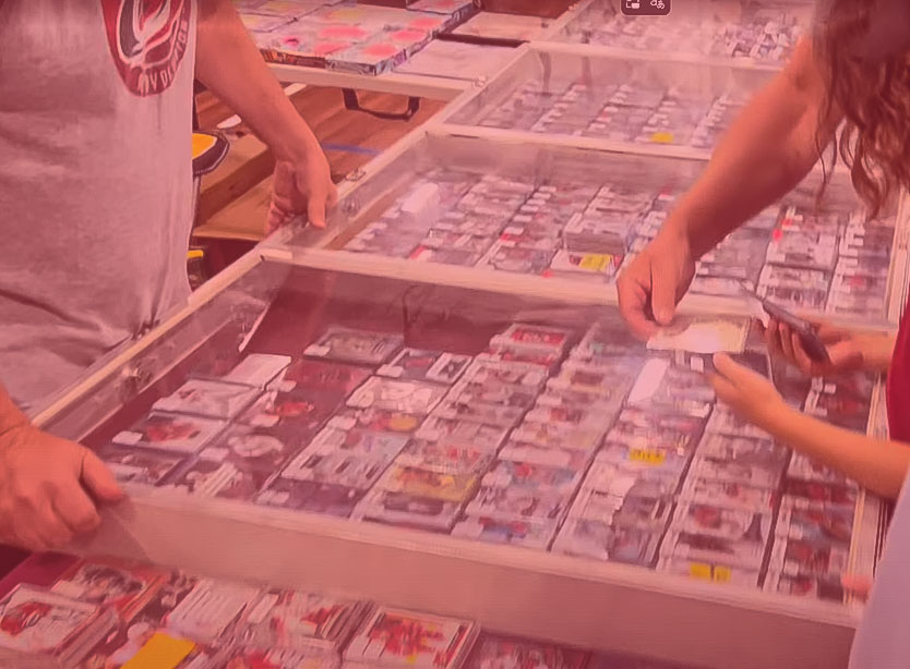 Collectors browsing tables of trading cards